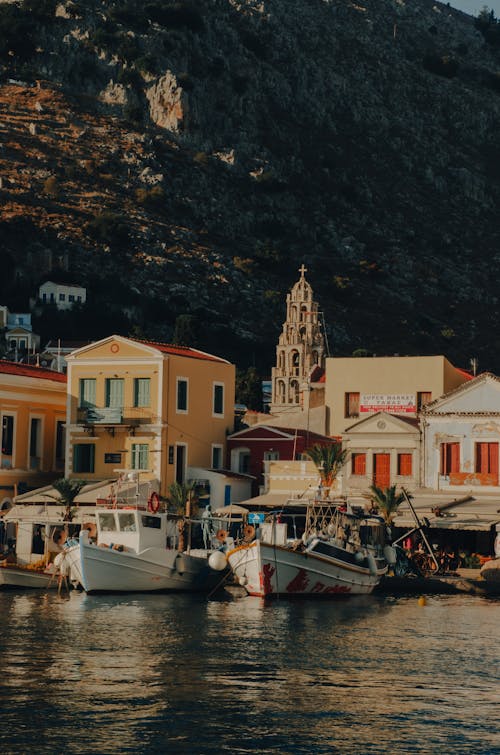 A boat is docked in front of a village