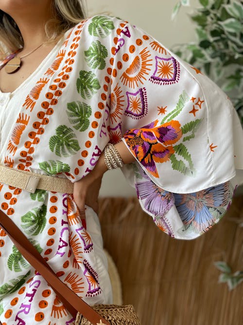 The woman is wearing a white and orange floral kimono