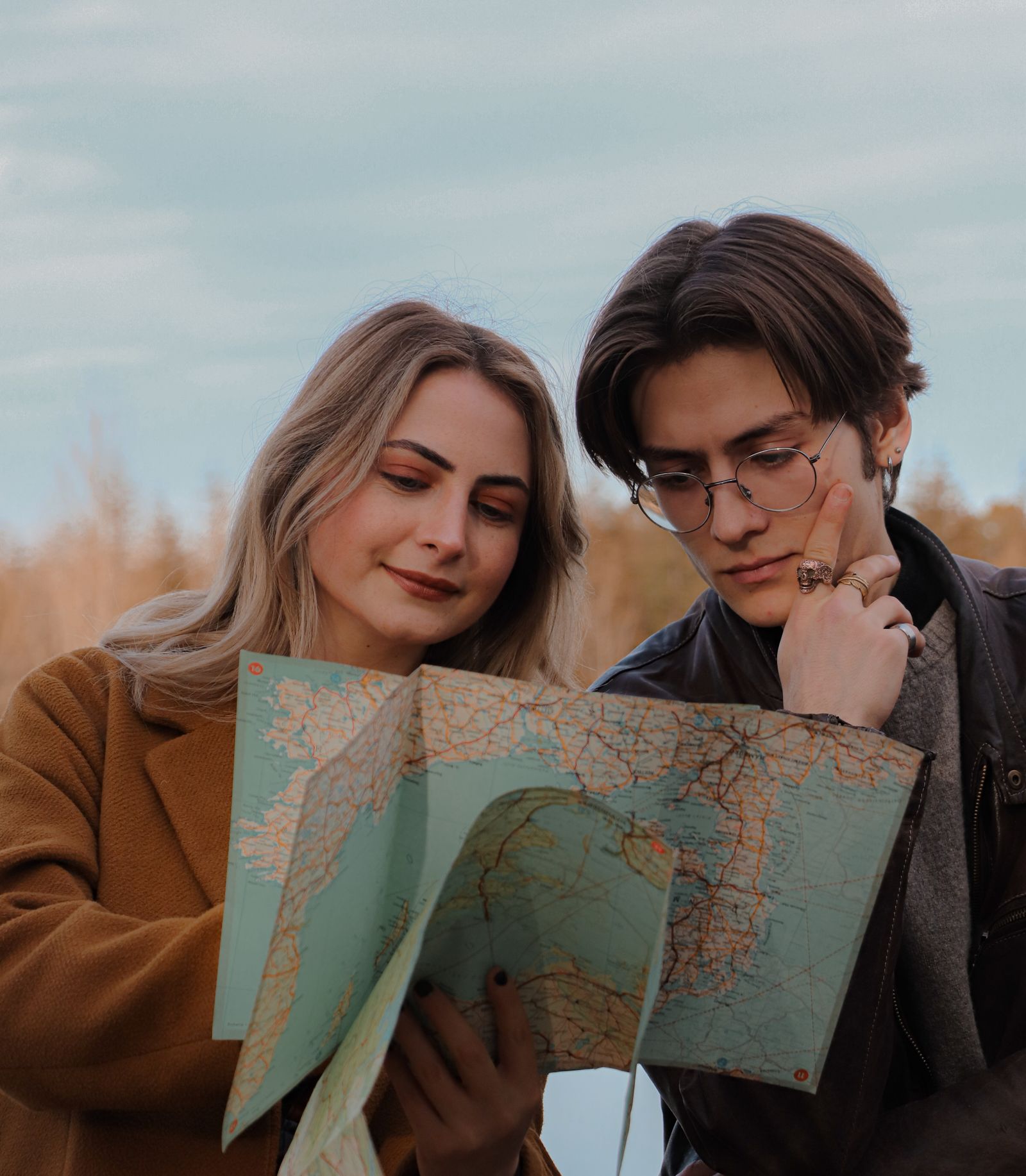 Two people looking at a map outdoors