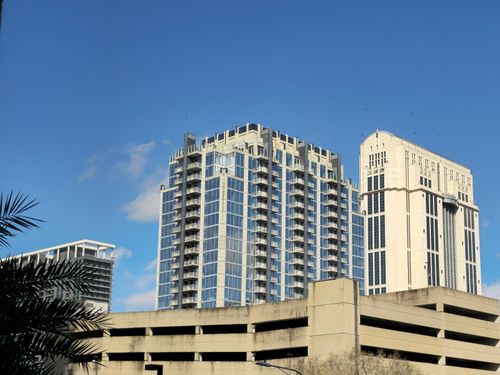 Free Skyline view of modern architecture including Post Oak Hotel under a clear blue sky. Stock Photo