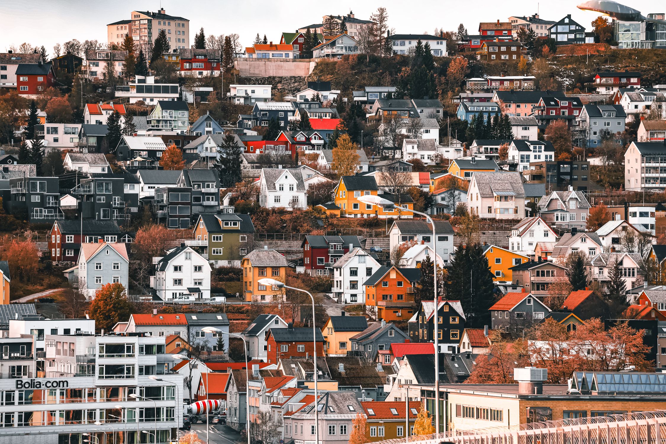 Vibrant hillside neighborhood in Tromso, Norway, showcasing colorful Nordic architecture.