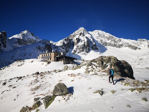 Hiker is Going to Shelter in Snowed Mountains