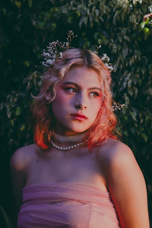 A woman with pink hair and a flower crown