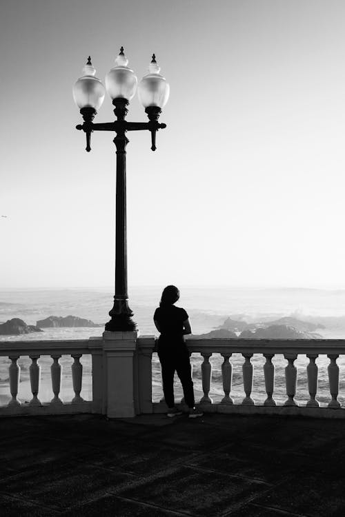 Woman in Promenade Looking at Choppy Ocean