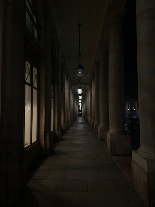 A long hallway with columns and lights