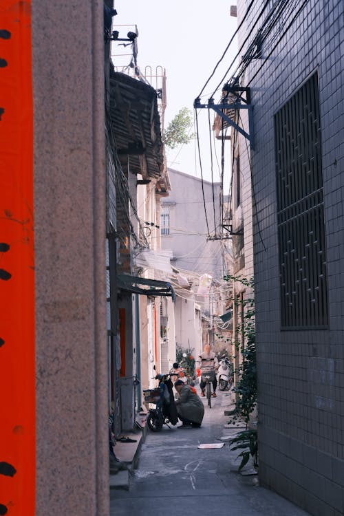 View of a Narrow Street between Buildings in City 