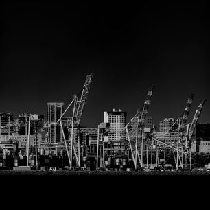 Harbor cranes above an urban waterfront — photo by Pablo Picardi Photography on Pexels