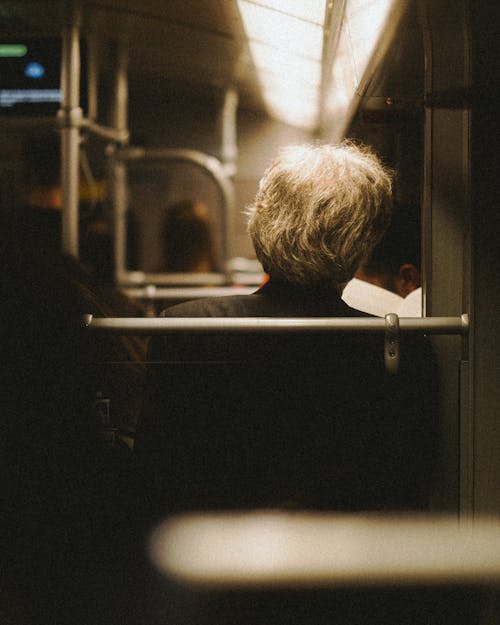 Back View of Man Sitting on Metro Train