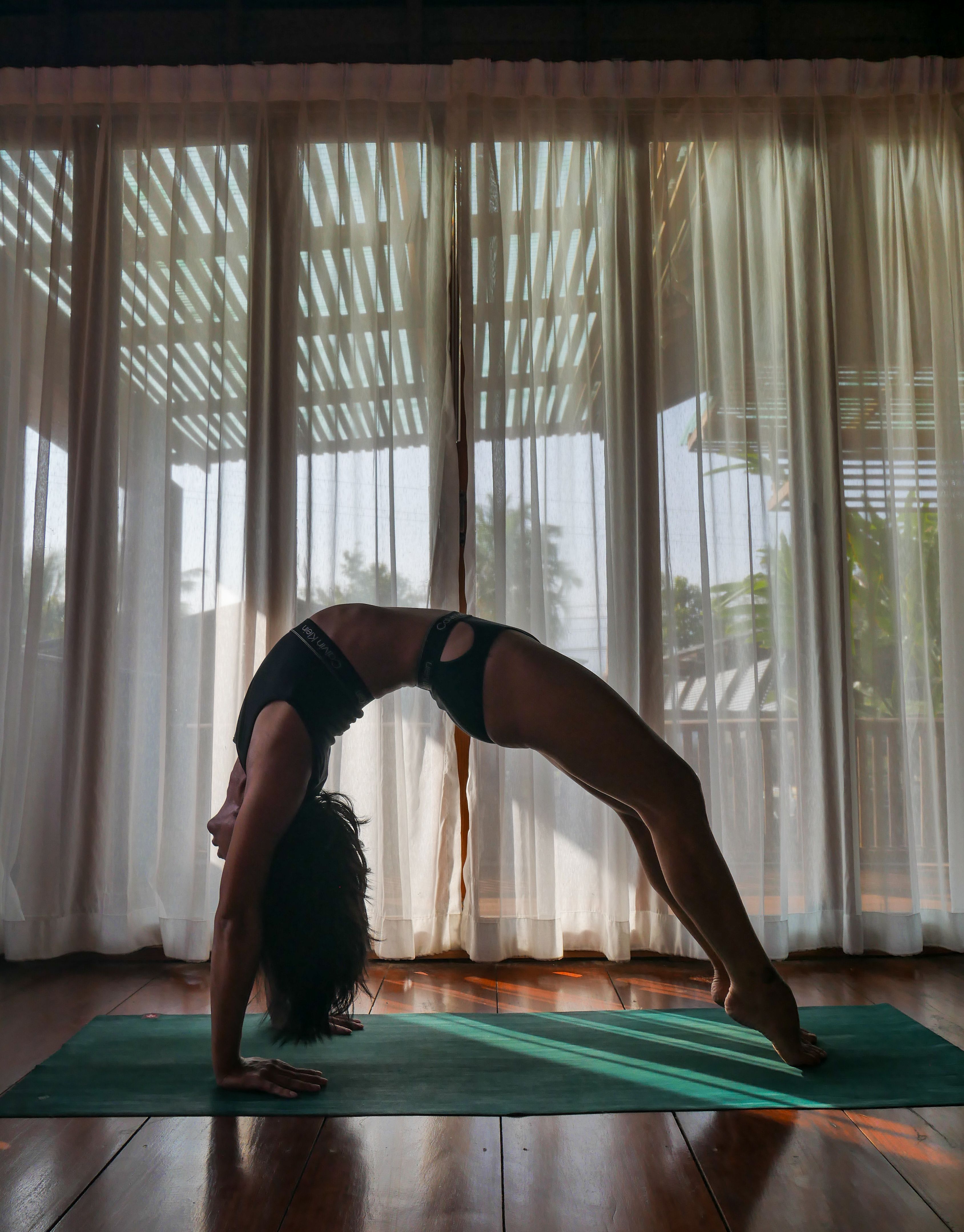 Woman Practising Yoga by the Window in a Room · Free Stock Photo