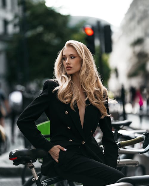 Young Woman in a Black Suit Posing in City 