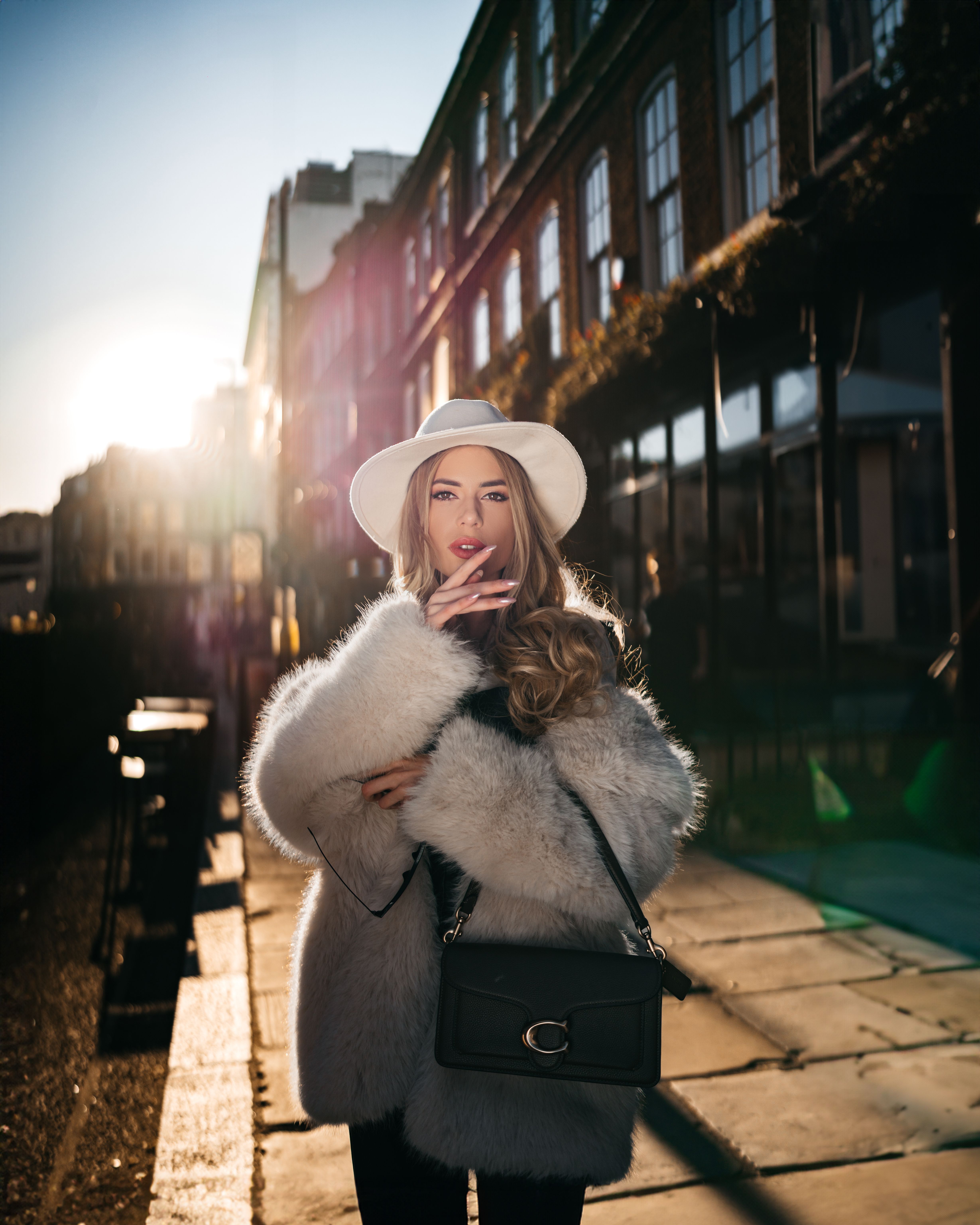 Woman Wearing Hat and Fur on a Street in Sunlight · Free Stock Photo