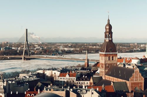 Free Aerial view of Riga, Latvia showcasing its iconic bridge and cathedral in winter. Stock Photo