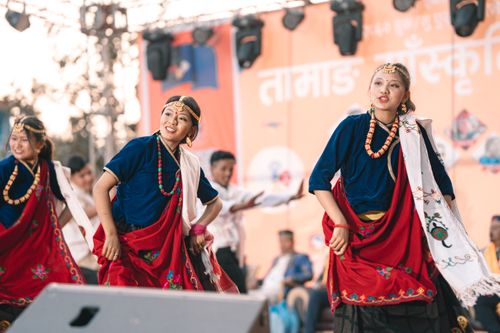 Free Colorful traditional festival with dancers in ethnic costumes performing joyfully on stage. Stock Photo
