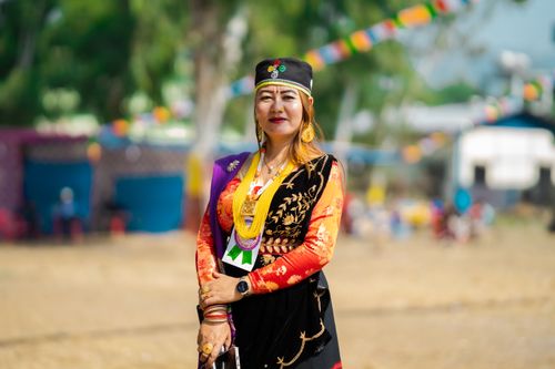 Free Woman in colorful traditional Nepalese dress at an outdoor celebration, showcasing cultural richness. Stock Photo