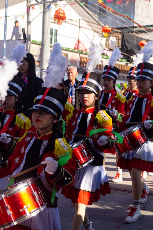 A group of children in costumes playing drums