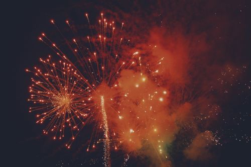 Free A stunning display of red fireworks lighting up the night sky, perfect for celebrations. Stock Photo