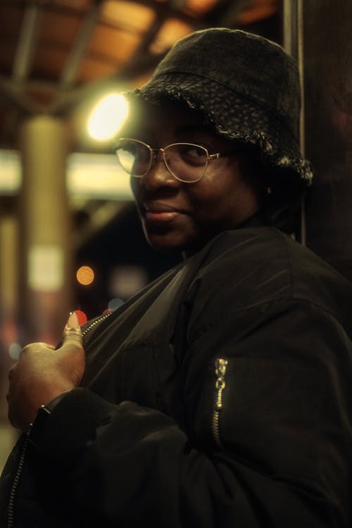 A black woman wearing glasses and a hat