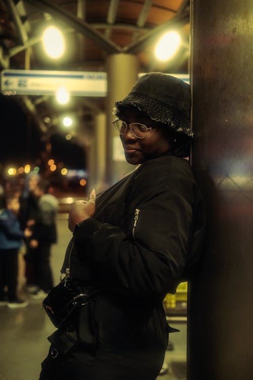 Woman Standing in Hat and Jacket