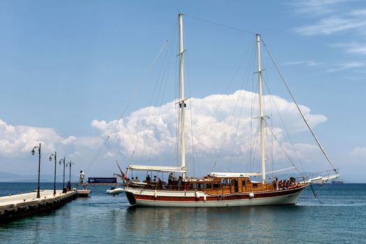 Elegant sailing ship moored at a pier on a sunny day in Kos, Greece, ideal for travel and tourism.