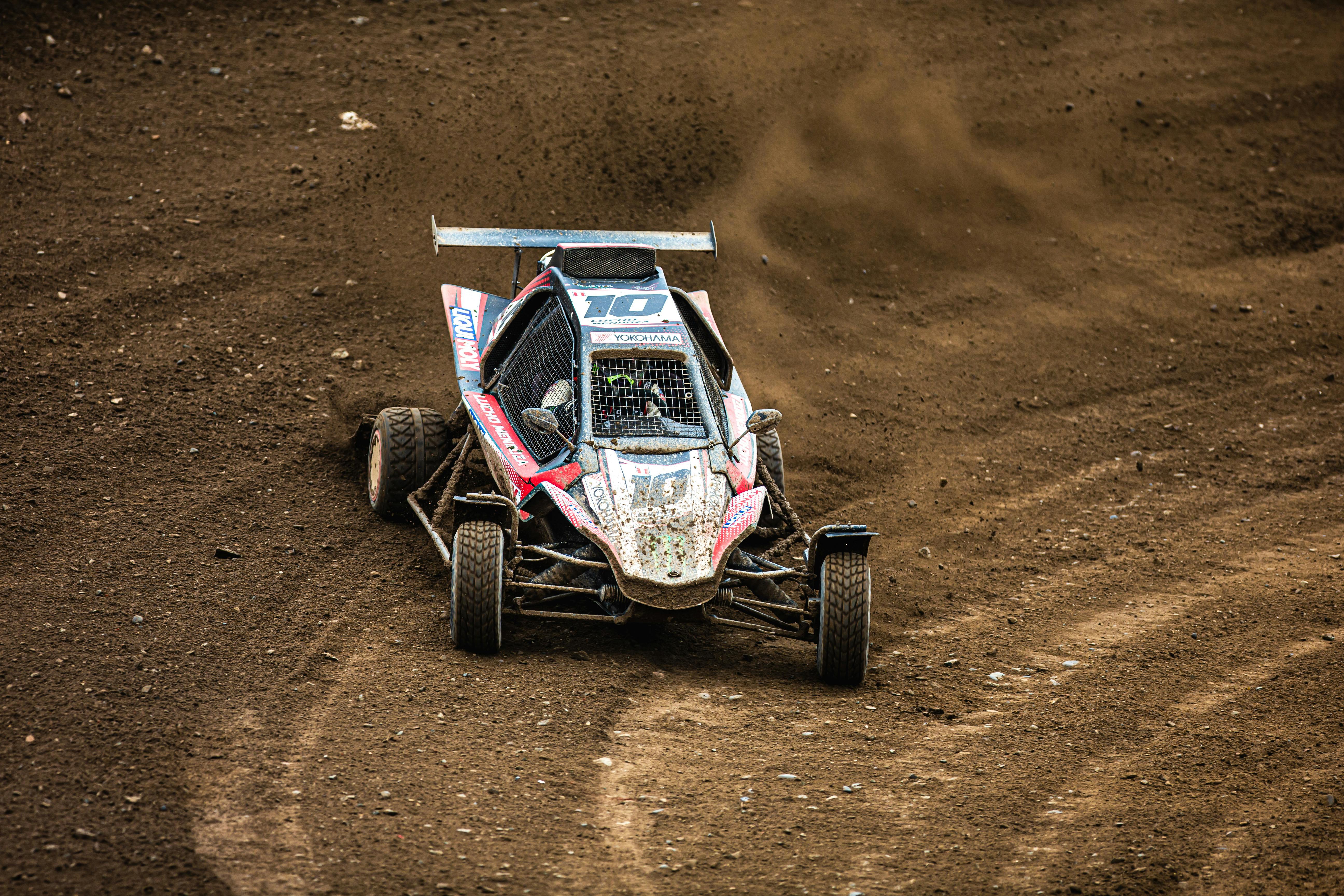 Exciting action shot of a quad racing vehicle speeding on a dirt track, showcasing dynamic movement.