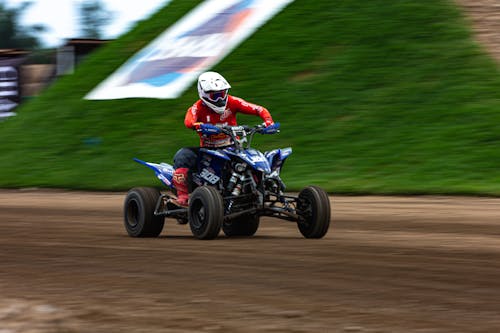 Free A person riding a four wheeler atv on a dirt track Stock Photo