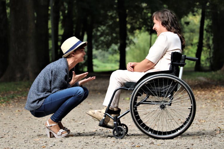 Woman On Black Folding Wheelchair