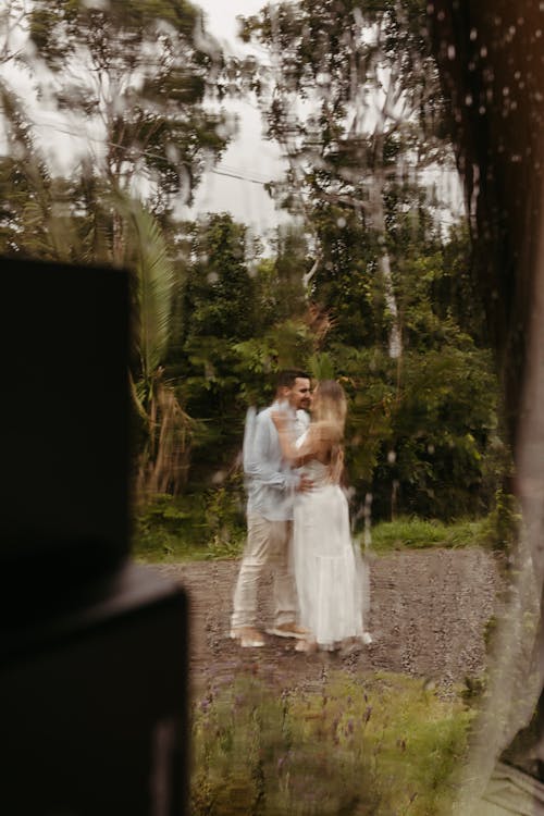 A couple is kissing in the woods