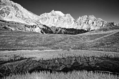 Black and white photo of mountains and water