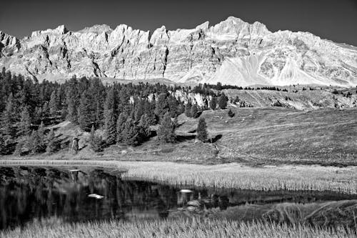 Black and white photo of mountains and water