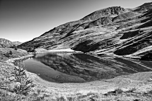 Black and white photograph of a lake in the mountains