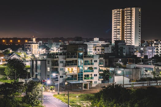Explore the vibrant urban nightscape of João Pessoa, Brazil, illuminated under city lights.