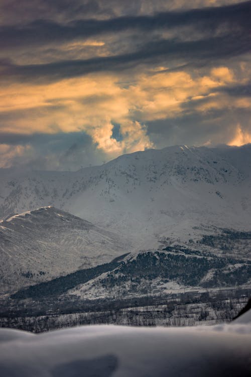 Free Snowy Mountains and Hills at Sunset Stock Photo