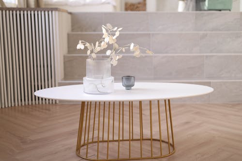 A white coffee table with gold accents
