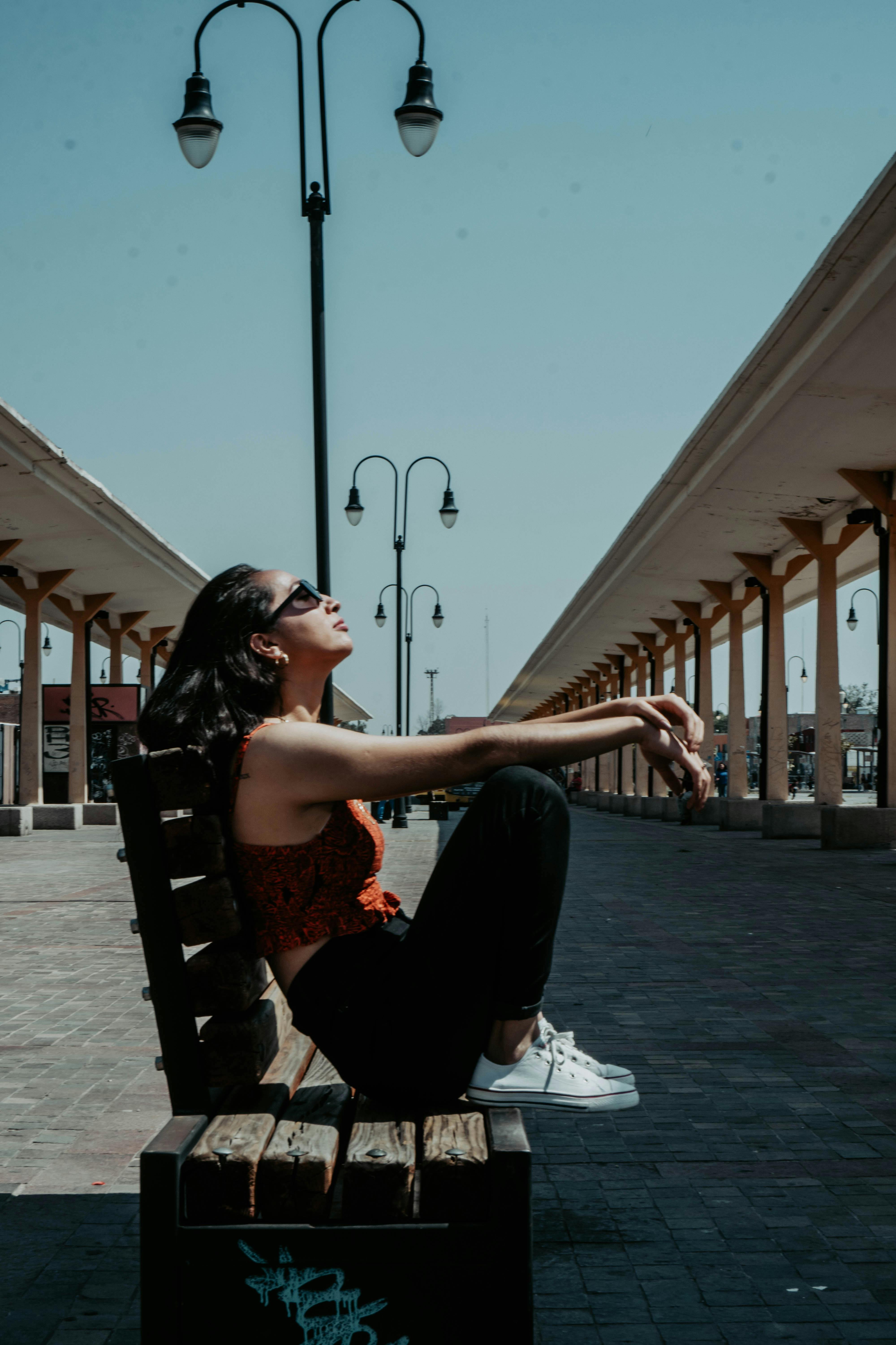 young woman sitting on a bench in summer