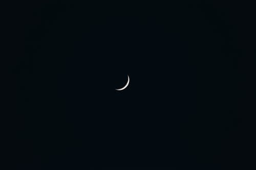 A crescent moon in the dark sky
