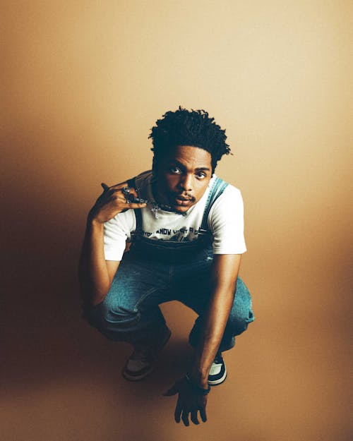 Portrait of a Young Man Crouching on the Floor 