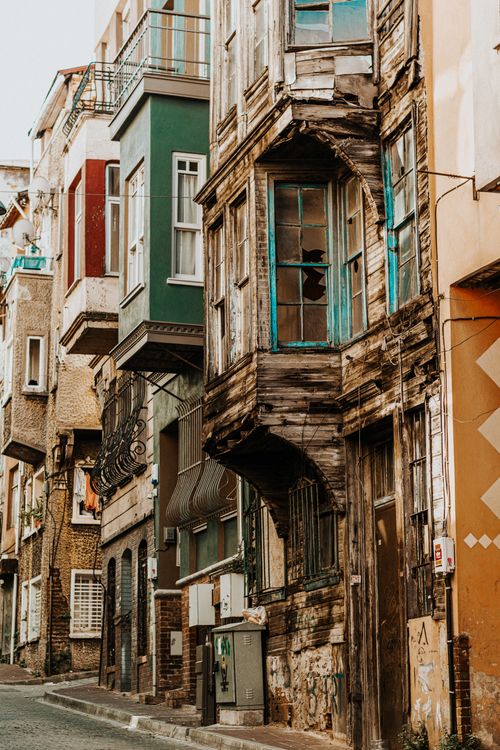 Free Colorful old townhouses line a narrow urban street in Istanbul's Balat neighborhood. Stock Photo