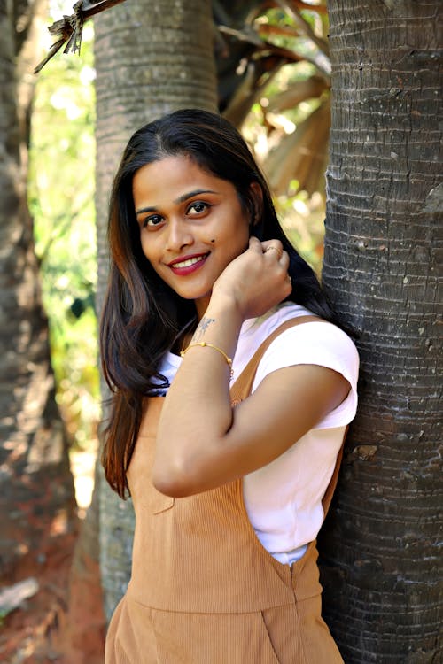 A young woman posing for a picture in a field