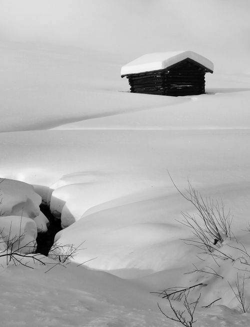 Free A serene snow-covered landscape with a rustic hut in Val di Vizze, Italy. Stock Photo