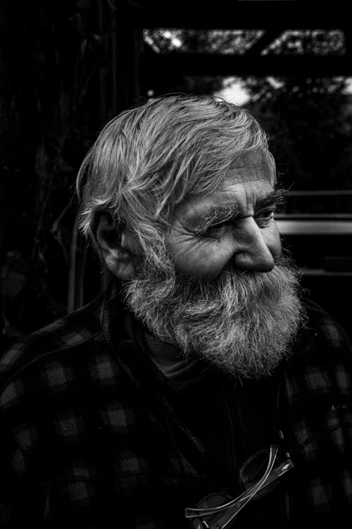 A black and white photo of a man with a beard