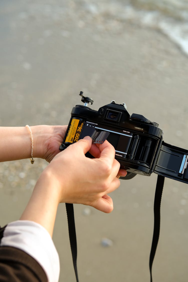 Woman Placing Film In Camera