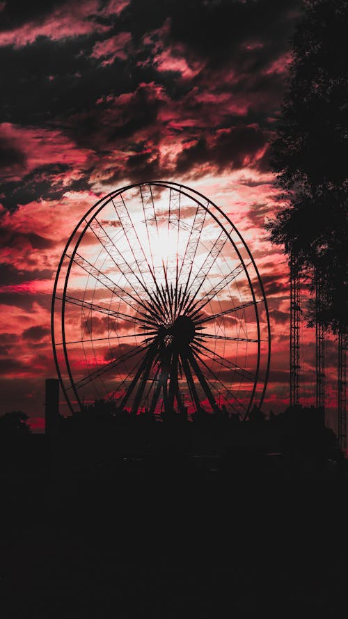 A photo of a ferris wheel at sunset