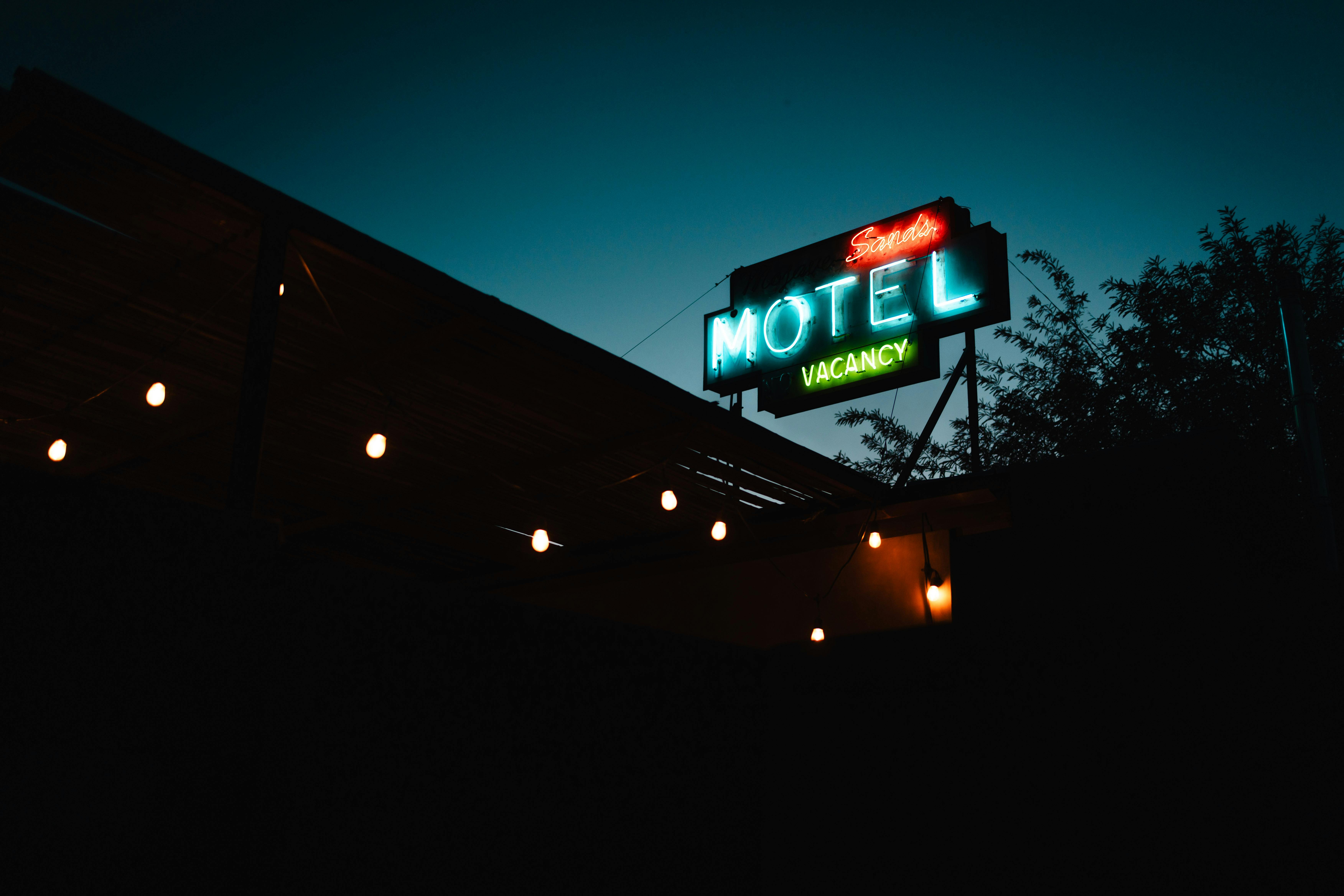 Vintage neon motel sign at dusk on Route 66 - 100th Anniversary of Route 66