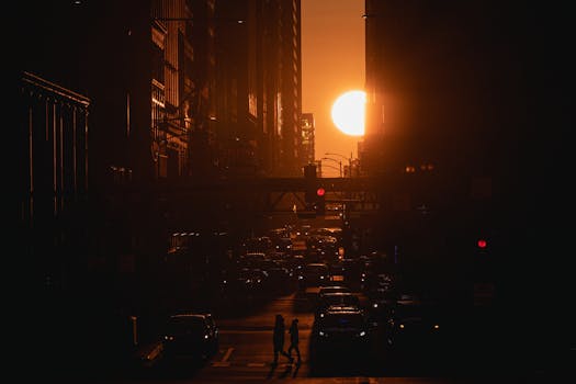 Silhouetted view of Chicago's downtown with cars and people against a stunning sunset.