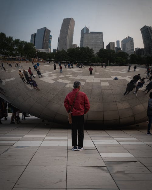 Back View of a Man Standing in Front of the Cloud Gate Sculpture in Chicago