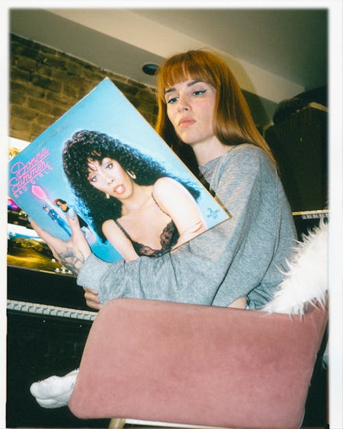 A woman holding a record in her hand