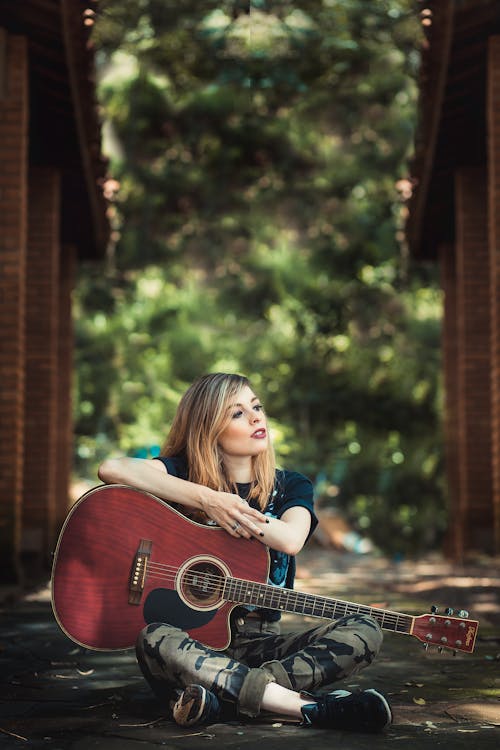 Free Woman Holding Red Guitar Stock Photo