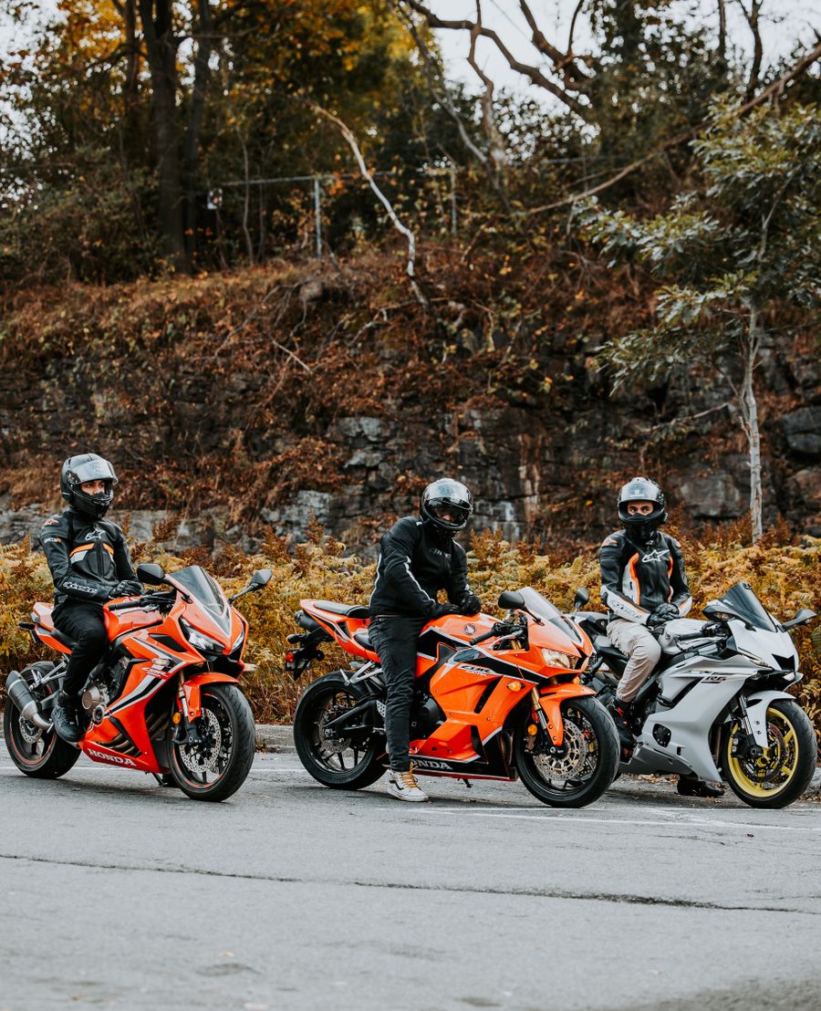 Crew of three sportbike riders stopped together on a mountain road
