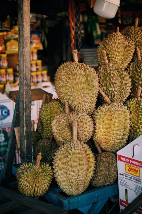 A bunch of durian fruit sitting on a table