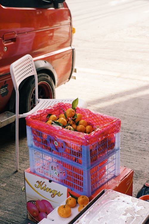 A red truck with a fruit stand on the side of the road